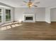 Living room featuring hardwood floors, fireplace, and large windows at 120 Birch Creek Cir, Mcdonough, GA 30253