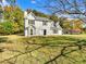 Two-story house with white siding, black shutters, and a landscaped lawn at 120 Birch Creek Cir, Mcdonough, GA 30253