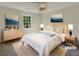 Virtually staged bedroom with light wood furniture, and neutral color palette at 120 Birch Creek Cir, Mcdonough, GA 30253