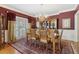 Formal dining room features hardwood floors, chandelier, and rich wall color at 1400 Lamont Cir, Dacula, GA 30019