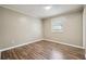 Bright bedroom with wood-look floors and a window at 5271 Kelleys Mill Cir, Stone Mountain, GA 30088