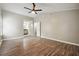 Main bedroom with hardwood floors, ceiling fan and ensuite bathroom at 5271 Kelleys Mill Cir, Stone Mountain, GA 30088
