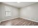 Bright bedroom with hardwood floors and a window at 5271 Kelleys Mill Cir, Stone Mountain, GA 30088