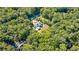 Aerial view of house nestled in a wooded area, showcasing expansive property and private setting at 1870 Chartwell Trce, Stone Mountain, GA 30087