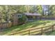 House exterior showcasing a red metal roof and wooden fence at 1552 Todd Ln, Lilburn, GA 30047