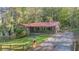 Ranch home exterior with red metal roof and a wooden fence at 1552 Todd Ln, Lilburn, GA 30047