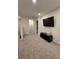 Upstairs hallway with TV, carpet, and access to bedrooms at 1702 Villageside Ct, Lawrenceville, GA 30043