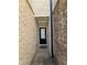 Private entryway with brick walls and a black front door leading into the home at 1702 Villageside Ct, Lawrenceville, GA 30043