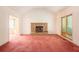 Living room with brick fireplace and pink carpet at 175 Carriage Gate Dr, Sharpsburg, GA 30277