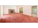 Living room with brick fireplace and pink carpet at 175 Carriage Gate Dr, Sharpsburg, GA 30277