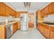Spacious kitchen with stainless steel appliances and oak cabinets at 175 Carriage Gate Dr, Sharpsburg, GA 30277