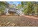 House back view, showcasing a deck and fenced backyard at 175 Carriage Gate Dr, Sharpsburg, GA 30277