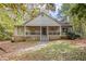 House exterior showcasing a wraparound porch and landscaping at 175 Carriage Gate Dr, Sharpsburg, GA 30277