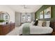 Main bedroom with green accent wall, king bed and natural light at 584 Silver Moon Dr, Loganville, GA 30052