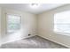 Bedroom with two windows, carpet, and neutral wall colors at 6263 Green Acres Sw Dr, Covington, GA 30014