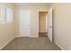 Spacious bedroom with neutral walls, carpet flooring, and an open door at 2465 Timberly Se Dr, Marietta, GA 30060