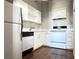 Compact kitchen with white cabinets and modern appliances at 20 Marietta Nw St # 17F, Atlanta, GA 30303