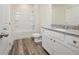 Clean bathroom with a shower/tub combo and granite countertop vanity at 4203 Shandi Cv, Hoschton, GA 30548