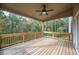 Wooden deck with ceiling fan, overlooking wooded area at 4203 Shandi Cv, Hoschton, GA 30548