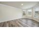 Spacious living room featuring large windows and hardwood floors at 4203 Shandi Cv, Hoschton, GA 30548
