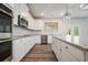 Modern kitchen with white cabinets, granite countertops and island at 4203 Shandi Cv, Hoschton, GA 30548