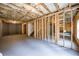 Unfinished basement with framed walls and concrete floor at 4203 Shandi Cv, Hoschton, GA 30548