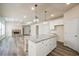 Modern kitchen with white cabinets, granite island and stainless steel appliances at 4203 Shandi Cv, Hoschton, GA 30548