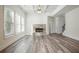 Living room with stone fireplace and hardwood floors at 4203 Shandi Cv, Hoschton, GA 30548