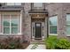Elegant front door entrance with brick detailing and landscaping at 4203 Shandi Cv, Hoschton, GA 30548