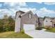 Attached garage with white door and landscaping at 4203 Shandi Cv, Hoschton, GA 30548