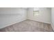 Bright walk-in closet with wire shelving and neutral carpeting at 4203 Shandi Cv, Hoschton, GA 30548