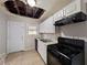 Kitchen with white cabinets, black appliances and damaged ceiling at 2904 Glenwood Se Ave, Atlanta, GA 30317