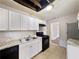 Kitchen features white cabinets, black appliances, and granite countertops at 2904 Glenwood Se Ave, Atlanta, GA 30317