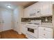 Kitchen with white cabinets, granite countertops, and stainless steel appliances at 5935 Sarah Orr Ln, Cumming, GA 30040