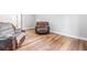 Basement sitting area with reclining chairs and wood flooring at 145 Oak Forest Dr, Oxford, GA 30054