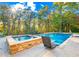 Inviting pool and spa area with stonework and surrounding trees at 145 Oak Forest Dr, Oxford, GA 30054