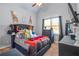 Bedroom with a dark-colored upholstered bed and window at 145 Oak Forest Dr, Oxford, GA 30054