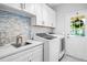 Laundry room with white cabinets, sink and exterior access at 145 Oak Forest Dr, Oxford, GA 30054