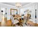 Formal dining room with a glass table and crystal chandelier at 145 Oak Forest Dr, Oxford, GA 30054