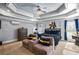 Bright main bedroom with sitting area and coffered ceiling at 145 Oak Forest Dr, Oxford, GA 30054