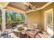 Relaxing outdoor deck with wicker furniture and ceiling fan, overlooking wooded area at 145 Oak Forest Dr, Oxford, GA 30054
