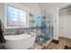 Elegant bathroom with soaking tub, glass shower, and designer tile at 145 Oak Forest Dr, Oxford, GA 30054
