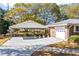 Attached carport with concrete parking area and landscaping at 2639 Odum St, Snellville, GA 30078