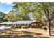 Brick ranch house with attached carport, landscaping, and a spacious yard at 2639 Odum St, Snellville, GA 30078