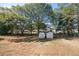 Large backyard with two storage sheds and mature trees at 2639 Odum St, Snellville, GA 30078