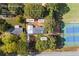 Aerial view of property showing home, carport, shed, and tennis courts at 2639 Odum St, Snellville, GA 30078