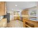 Galley kitchen with light wood cabinets, granite counters and tile floor at 2639 Odum St, Snellville, GA 30078