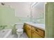 Bathroom with light green tile and wood vanity at 2639 Odum St, Snellville, GA 30078