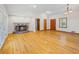 Open living room with hardwood floors and a cozy fireplace at 2639 Odum St, Snellville, GA 30078