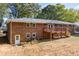 Brick ranch house featuring a deck and backyard view at 2639 Odum St, Snellville, GA 30078